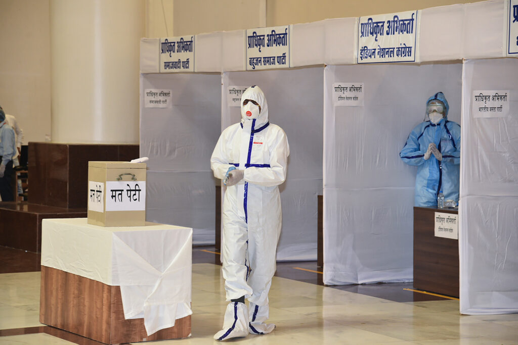 Congress MLA Kunal Choudhary, wearing personal protective equipment, casts his vote for Rajya Sabha Council of States elections in Bhopal, India on June 19.