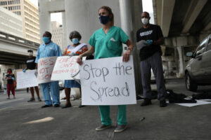 Volunteers, health care workers and doctors participate in a protest in April in Miami.