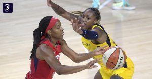 WNBA female basketball players go to the United States anthem