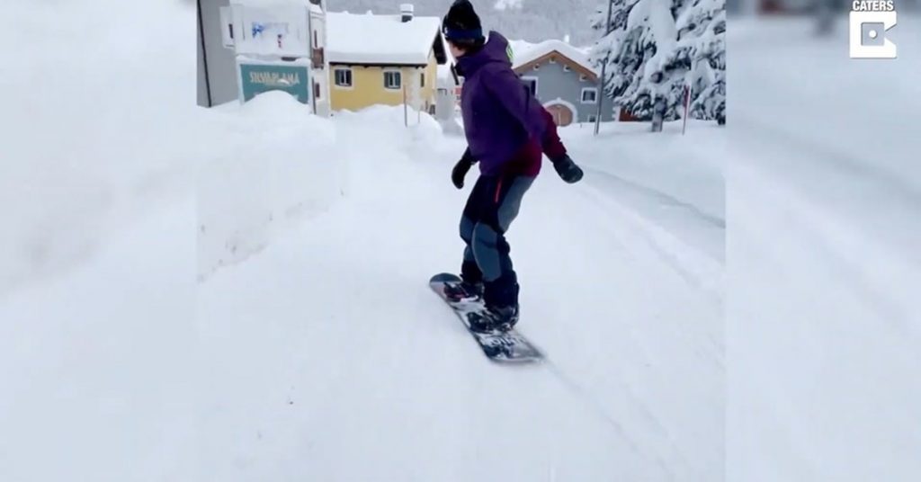 Disconnect.  - This man is skiing in the snow-covered streets of Switzerland