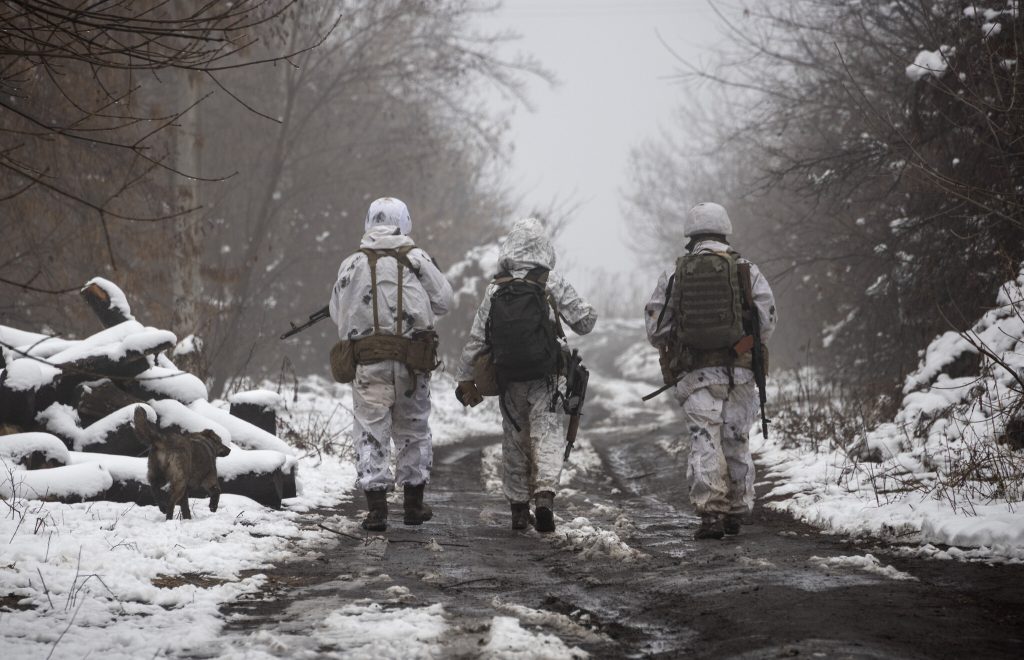 Ukrainian soldiers walks at the line of separation from pro-Russian rebels near Katerinivka, Donetsk region, Ukraine, Tuesday, Dec 7, 2021. Ukrainian authorities on Tuesday charged that Russia is sending tanks and snipers to the line of contact in war-torn eastern Ukraine to