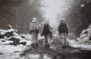 Ukrainian soldiers walks at the line of separation from pro-Russian rebels near Katerinivka, Donetsk region, Ukraine, Tuesday, Dec 7, 2021. Ukrainian authorities on Tuesday charged that Russia is sending tanks and snipers to the line of contact in war-torn eastern Ukraine to