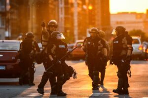 Police officers take guard during a protest over the death of George Floyd on May 31, in Minneapolis, Minnesota.