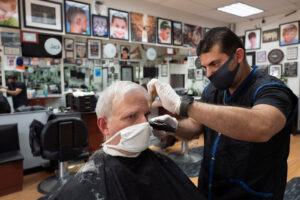 Howard Kaplan gets a haircut from Eli Gilkarov at Jack's Barbershop, on June 9, in Larchmont, New York.