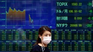 A face mask is seen in front of the New York Stock Exchange (NYSE) on May 26, 2020 at Wall Street in New York City. - Global stock markets climbed Monday, buoyed by the prospect of further easing of coronavirus lockdowns despite sharp increases in case rates in some countries such as Brazil. Over the weekend, US President Donald Trump imposed travel limits on Brazil, now the second worst affected country after the United States, reminding markets that while the coronavirus outlook is better, the crisis is far from over. (Photo by Johannes EISELE / AFP) (Photo by JOHANNES EISELE/AFP via Getty Images)