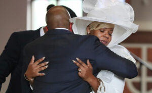 Rev. Raphael G. Warnock comforts Tomika Miller, the wife of Rayshard Brooks, during Brooks'  public viewing at Ebenezer Baptist Church on Monday, June 22 in Atlanta.