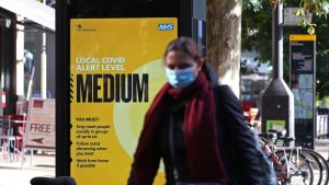 A masked shopper in Ealing, west London, where Tier 2 restrictions are now in place